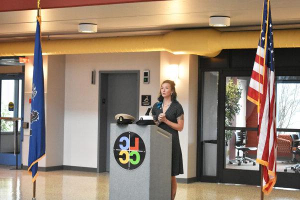 Image shows a veteran student speaking at a podium next to the American and Pennsylvanian flags. The LCCC logo is on the podium.